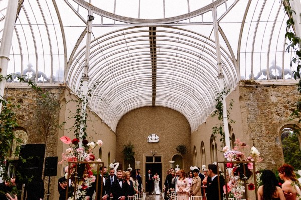 Bride walks up with aisle guests wait