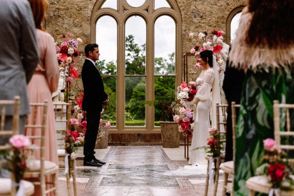 Bride groom and officiant at the alter interior church