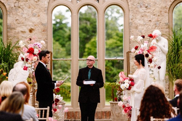 Bride groom and officiant at the alter interior church