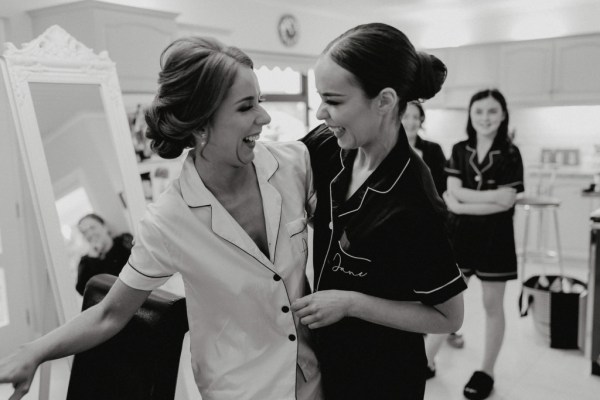 Black and white image of sisters bride and bridesmaid in bridalwear