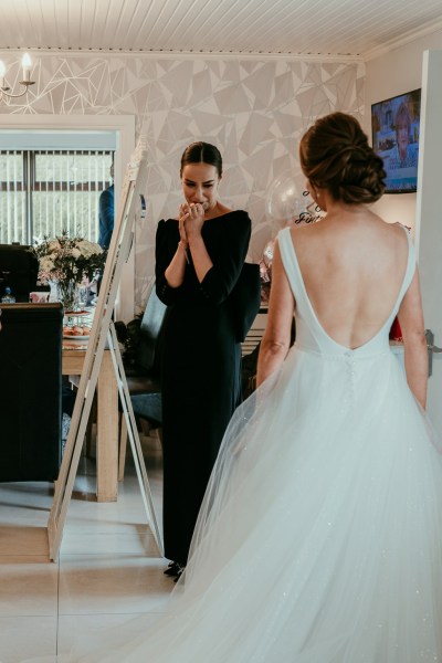 Bride and bridesmaid in room together