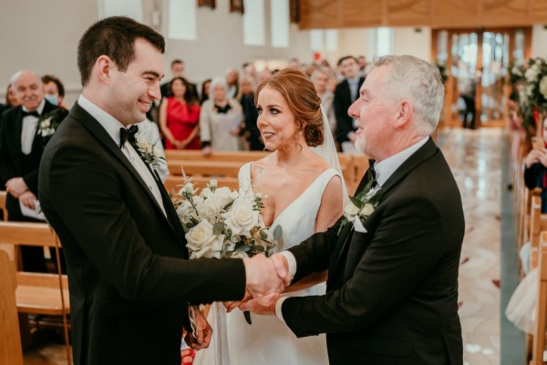 Bride and groom with father at alter to church