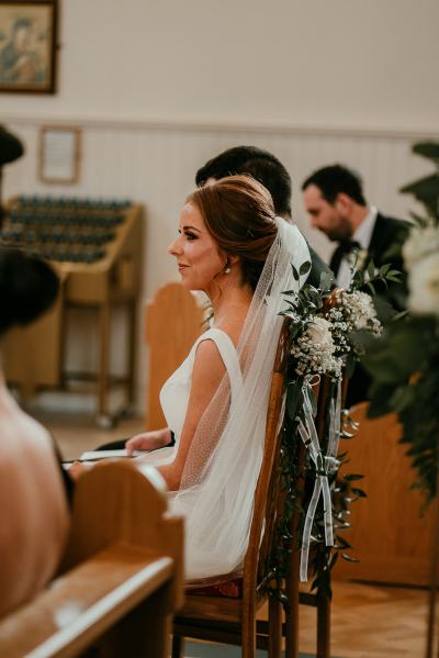 Bride and groom sitting at top of church ceremony