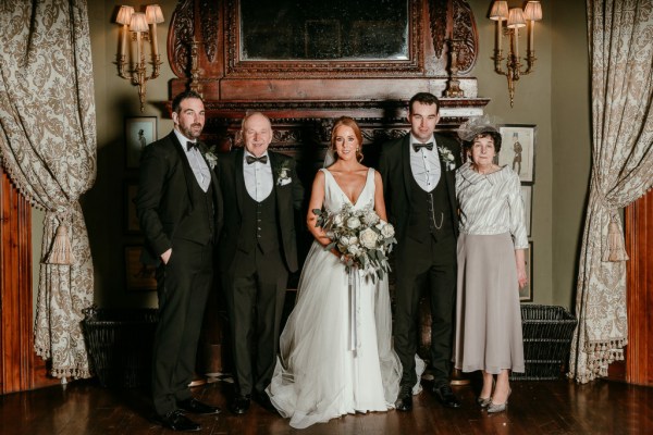 Family shot of bride groom mother father and groomsman/brother