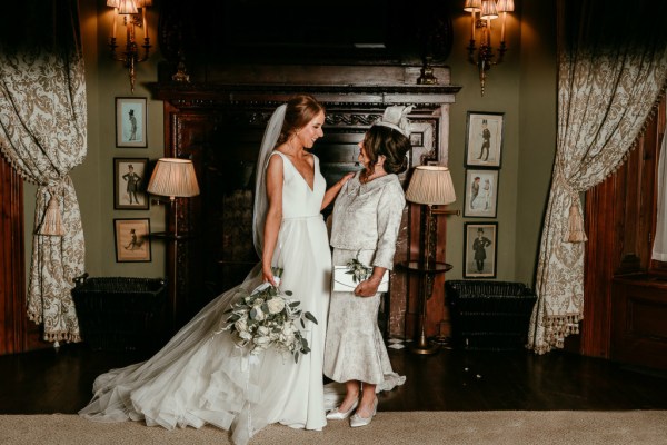 Bride laughs with mother