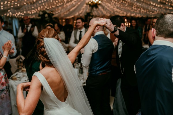 Bride and groom enter ballroom hands in the air