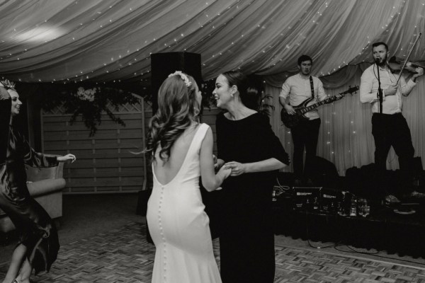 Black and white bride and friend dancing dancefloor