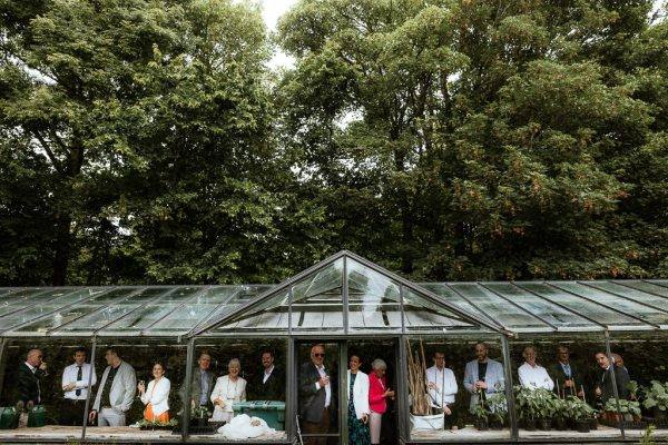 Atmosphere shot of guests under glasshouse marquee