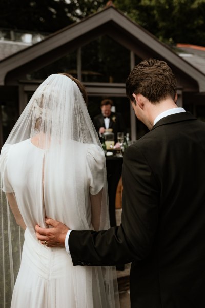 Groom has arm around bride