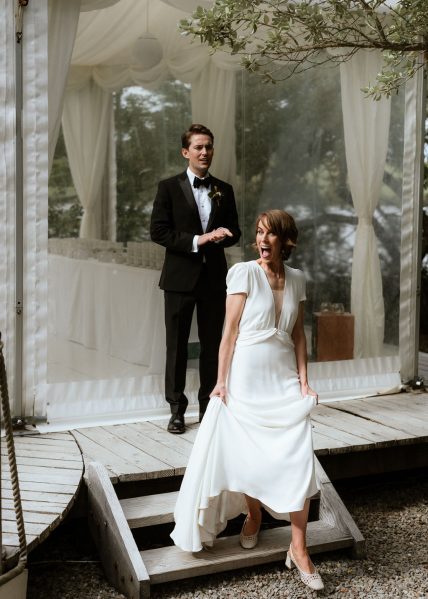 Bride and groom standing on boardwalk