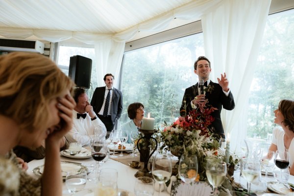 Groom gives speech to guests microphone