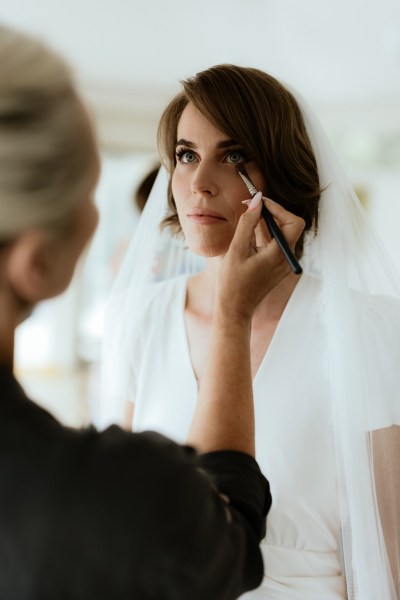 Bride gets her makeup done by MUA