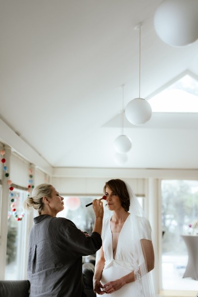 Bride gets her makeup done by MUA