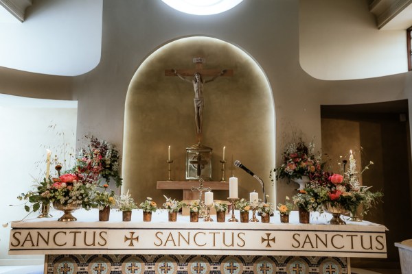 Interior church alter setting with candles and flowers