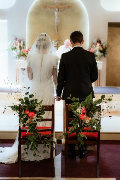 Couple from behind at alter bride and groom