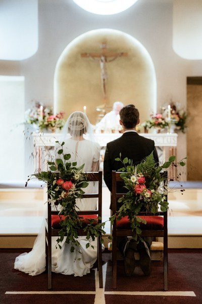 Couple from behind at alter bride and groom