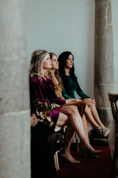 Guests look at bride and groom as they're seated during ceremony