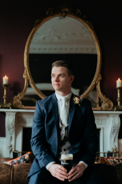 Groom standing on his own in room