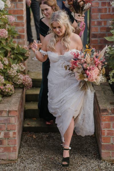 Bride and groom walk down the steps together