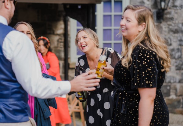 Female guests are laughing celebrating and drinking