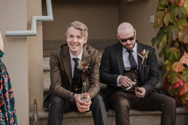 Groom and groomsman sitting down