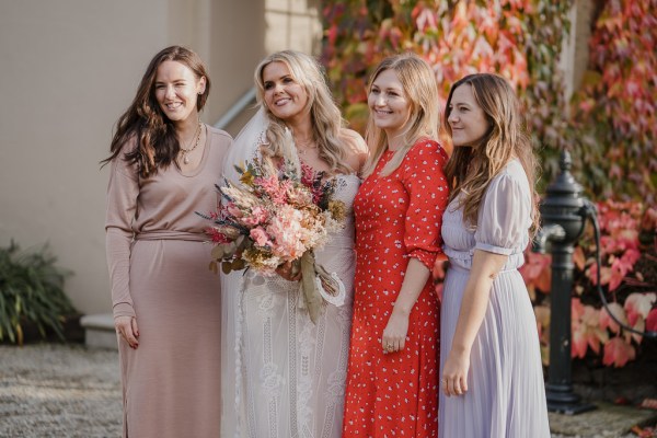 Bride and friends guests pose for a picture