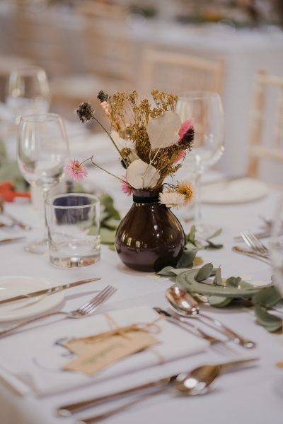 Empty dining room ballroom flowers candles and glasses on table