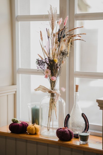 Flowers in vase at window sill