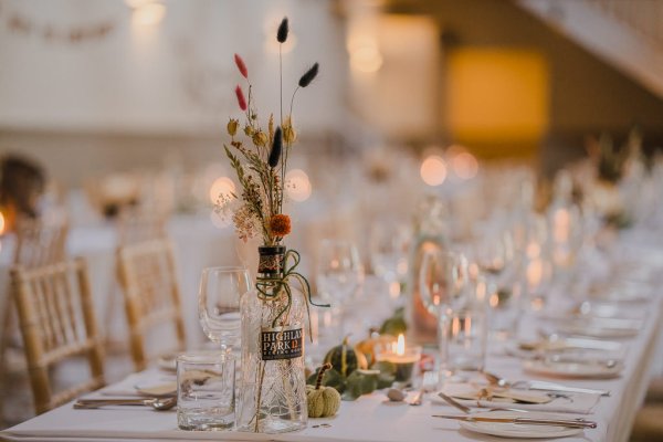 Empty dining room ballroom flowers candles and glasses on table