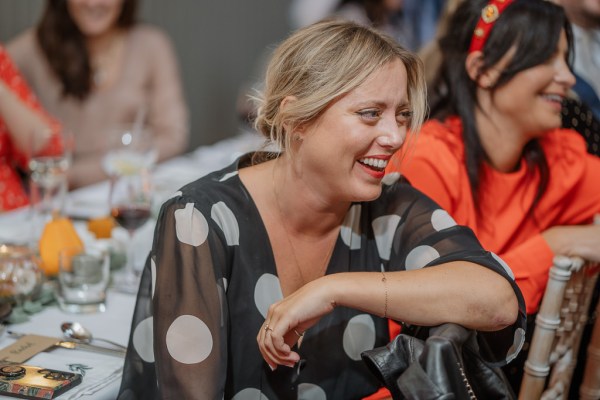 Woman in polka dot dress laughs