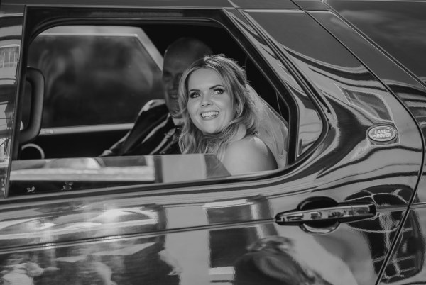 Black and white image of bride and father in wedding car