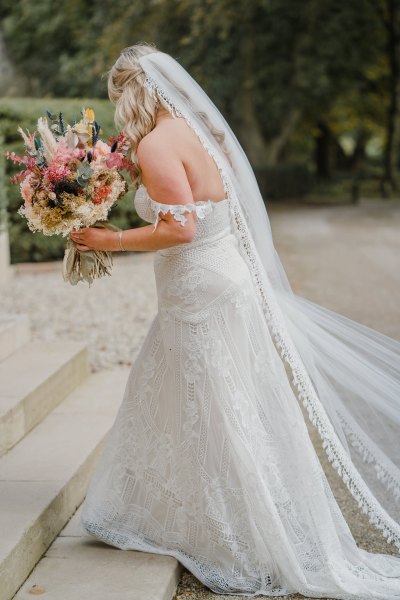 Bride lace dress detail gown walking up steps