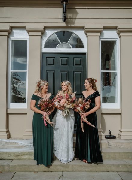 Bride and bridesmaids look at each other