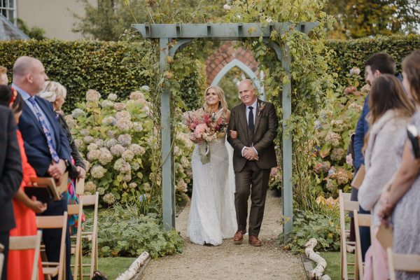 The father of the bride walks down the aisle together