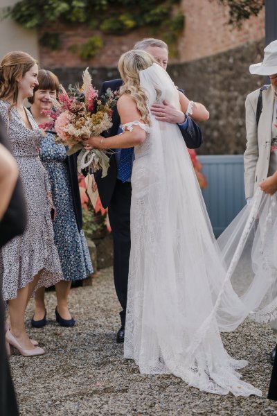 Guests hug the bride happy