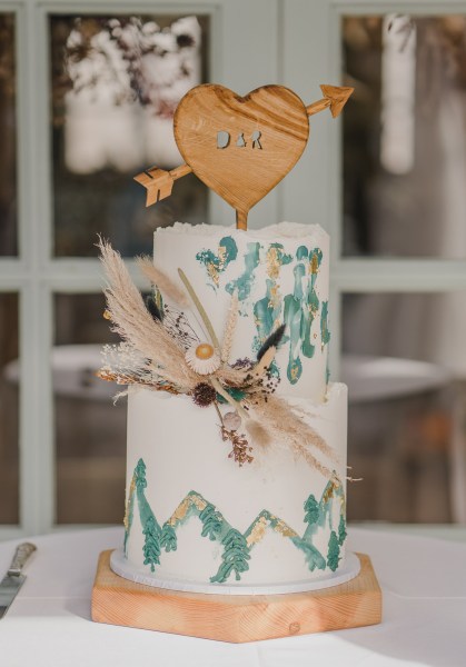 Bride and groom cut the wedding cake together