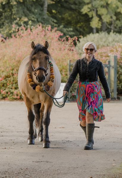 Woman walks horse