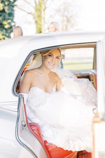 Bride gets out of wedding car