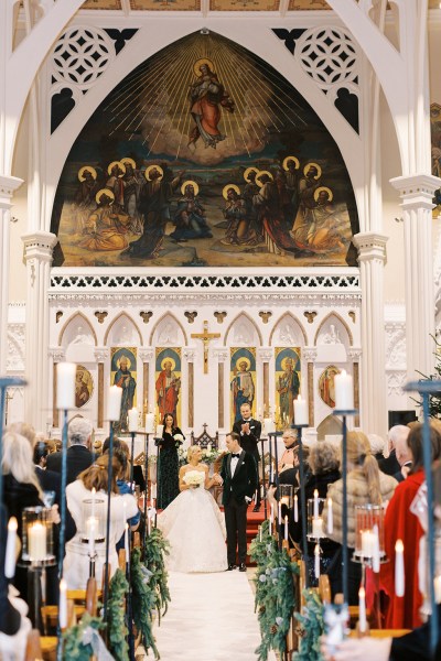 Bride and groom hand in the air exiting church