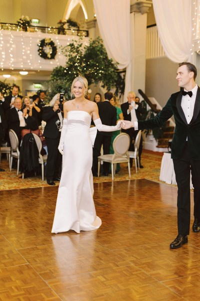 Bride and groom enter ballroom hand in hand