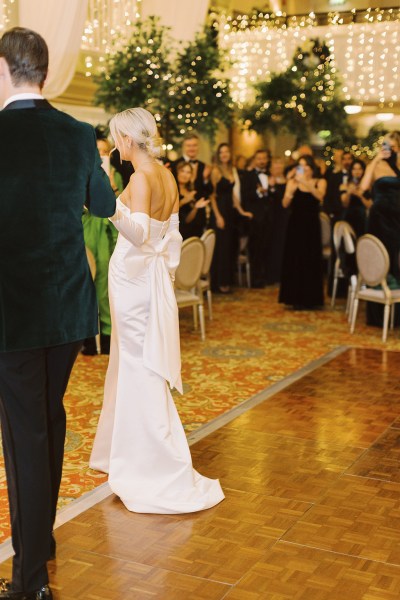 Bride and groom enter ballroom hand in hand