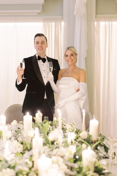 Bride and groom give speech and kiss in front of guests