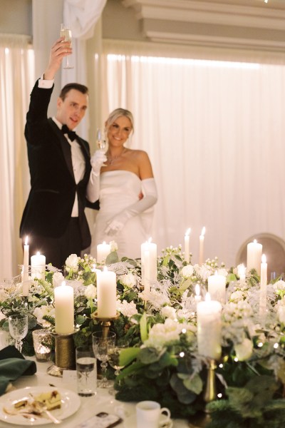 Bride and groom give speech and kiss in front of guests