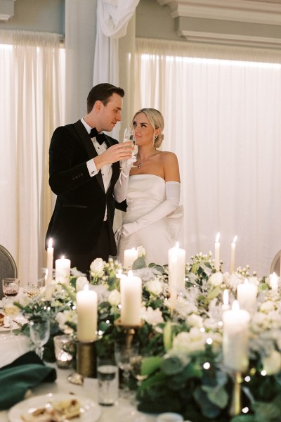 Bride and groom give speech and kiss in front of guests