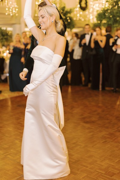 Bride and groom dance on the dancefloor in front of guests