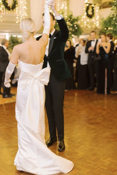 Bride and groom dance on the dancefloor in front of guests