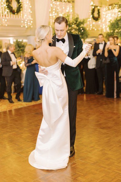 Bride and groom dance on the dancefloor in front of guests