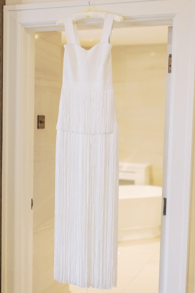 Bridal gown dress hanging at doorframe