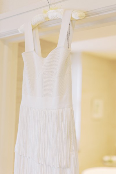 Bridal gown dress hanging at doorframe