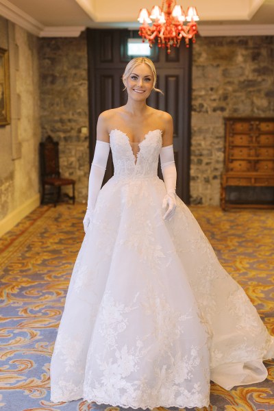 Bride stands on her own ready in bedroom